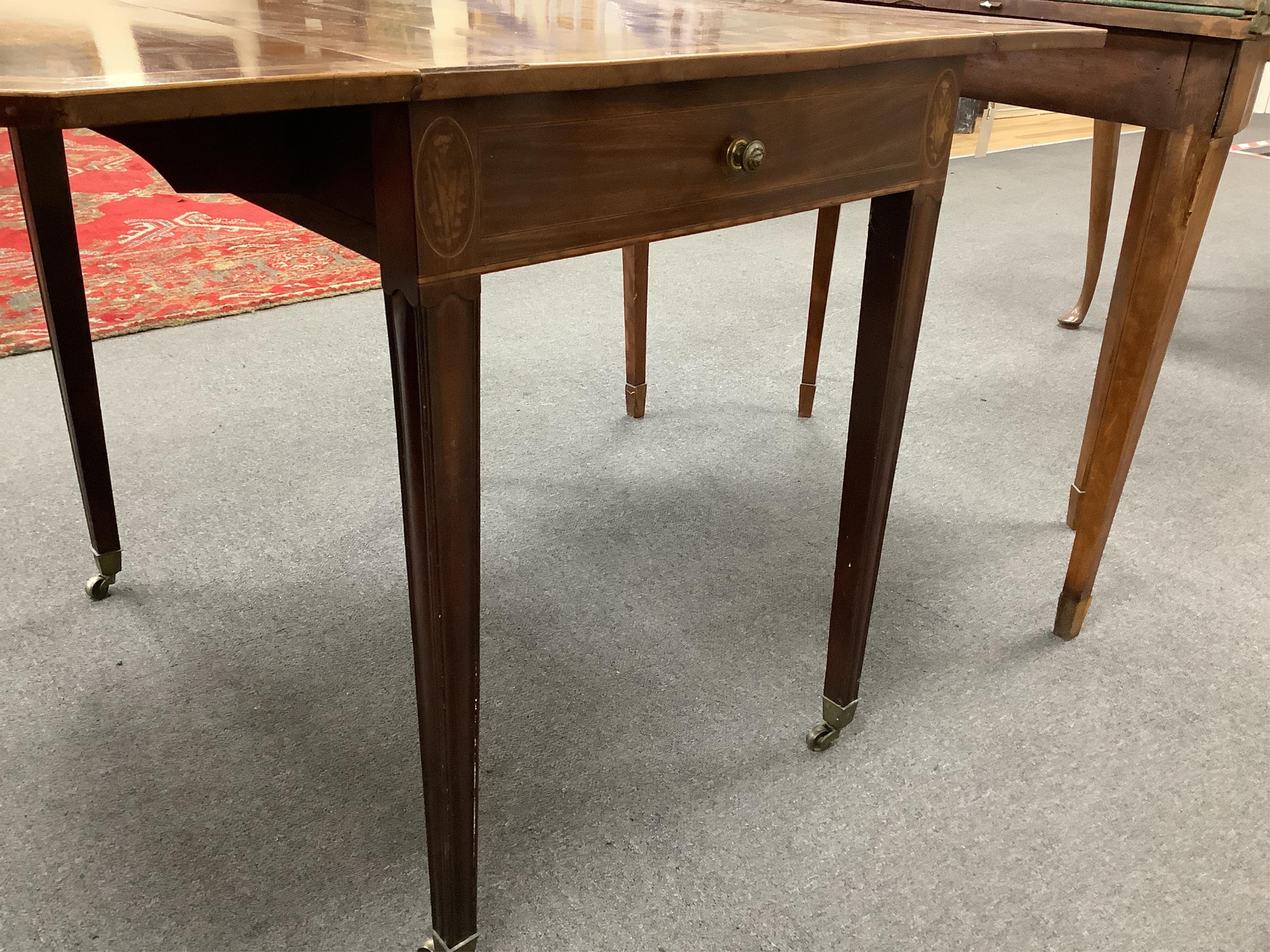 A George III crossbanded mahogany Pembroke table, with canted rectangular flaps and frieze drawer, on moulded squared tapered legs, fitted brass castors, 84cm wide, 54cm deep, 72cm high. Condition - overall of a slightly